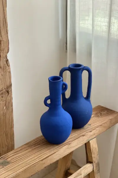 שני כלי חרס בכחול מז׳ורל על ספסל עץ